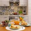 Kitchen area with a dining table for four, kitchen cabinets, stov