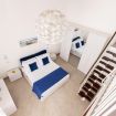 The main bedroom features a queen bed, bedside table, fresh linen